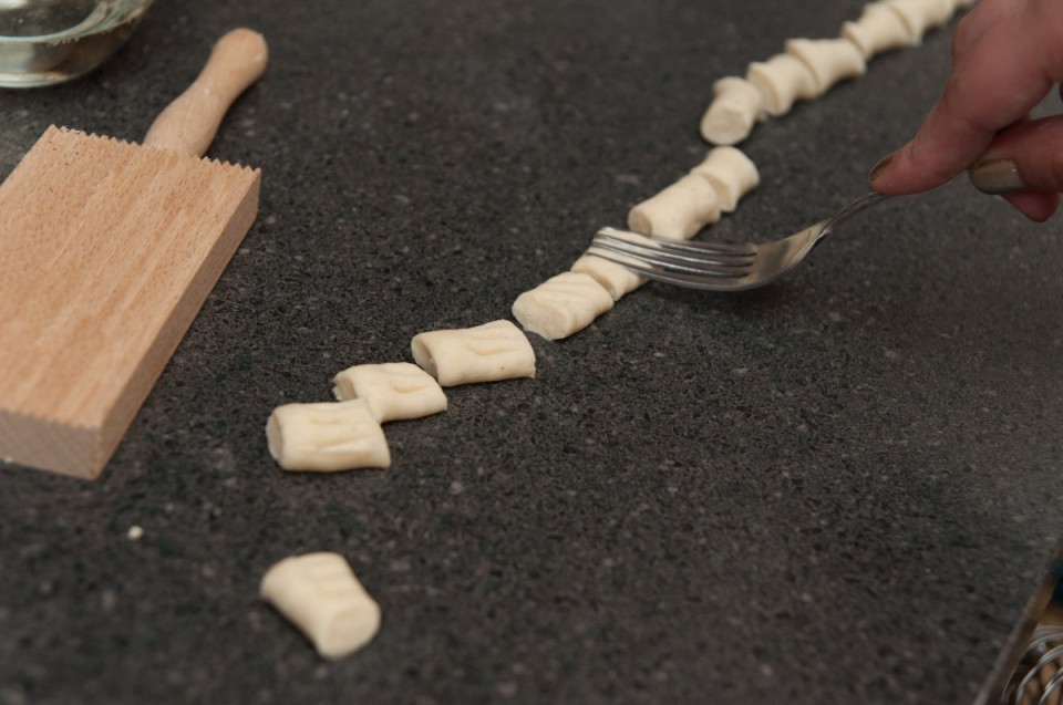 If you don't have a fancy gnocchi board you can use a fork. Gently indent your gnocchi.